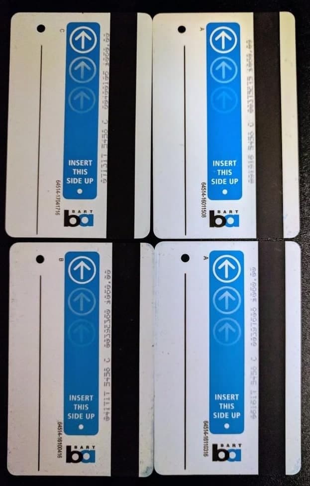 Four BART paper tickets with blue strips and white arrow symbols